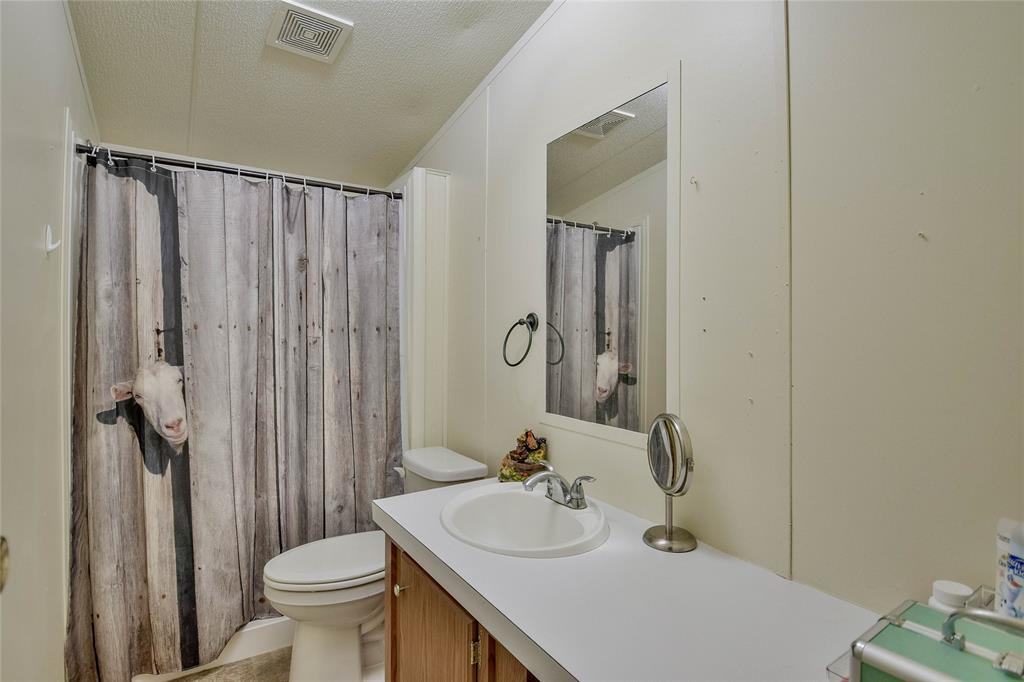 214 Gandy Street Lipan, TX 76462 - Photo 30 of 40 a bathroom with a sink toilet and shower