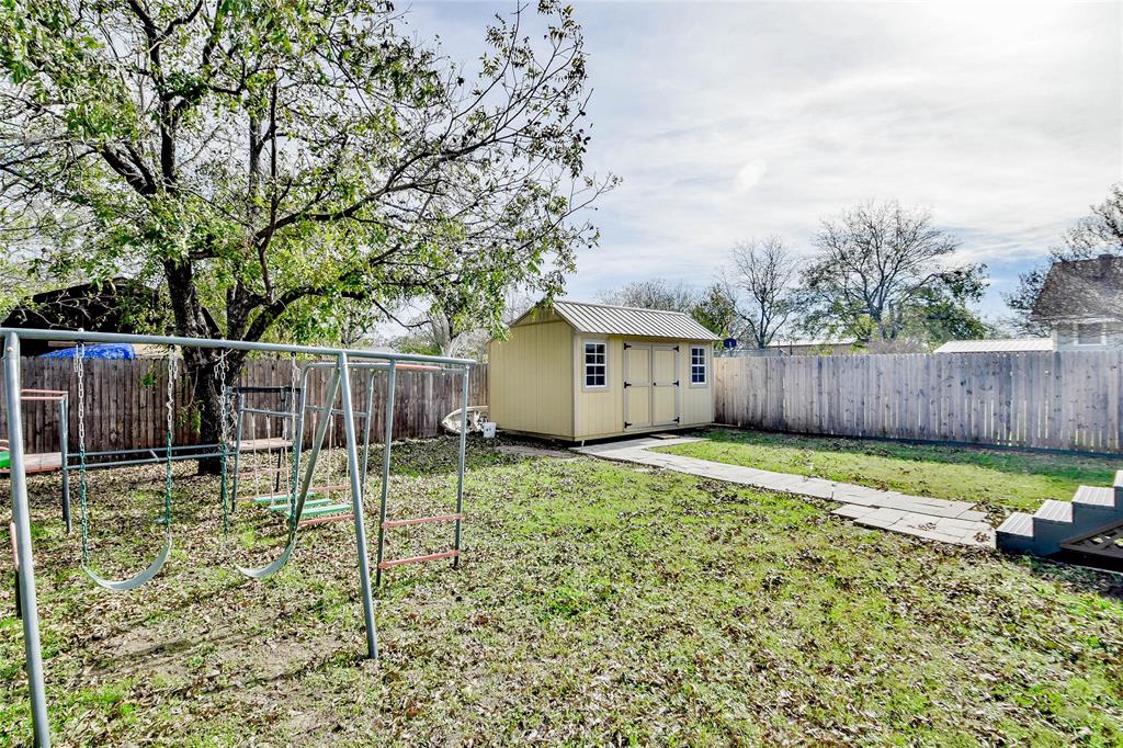 214 Gandy Street Lipan, TX 76462 - Photo 40 of 40 a backyard of house with swing and slide