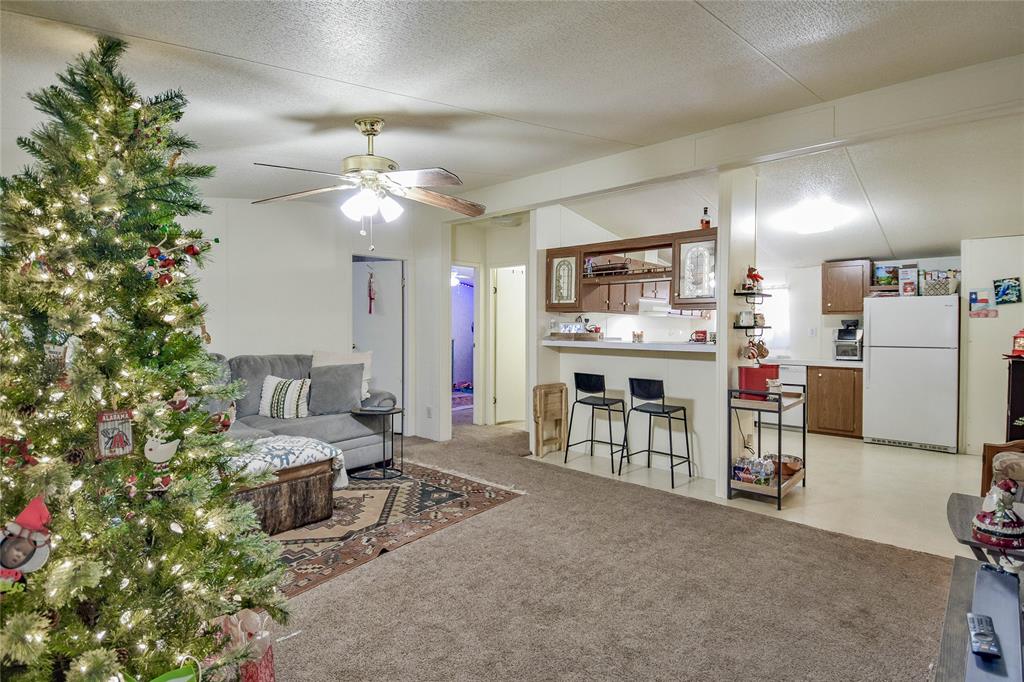 214 Gandy Street Lipan, TX 76462 - Photo 7 of 40 a living room with furniture and a kitchen
