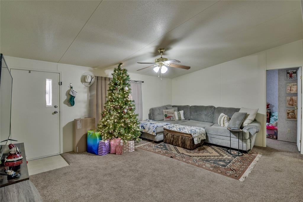 214 Gandy Street Lipan, TX 76462 - Photo 8 of 40 a living room with furniture and flowers