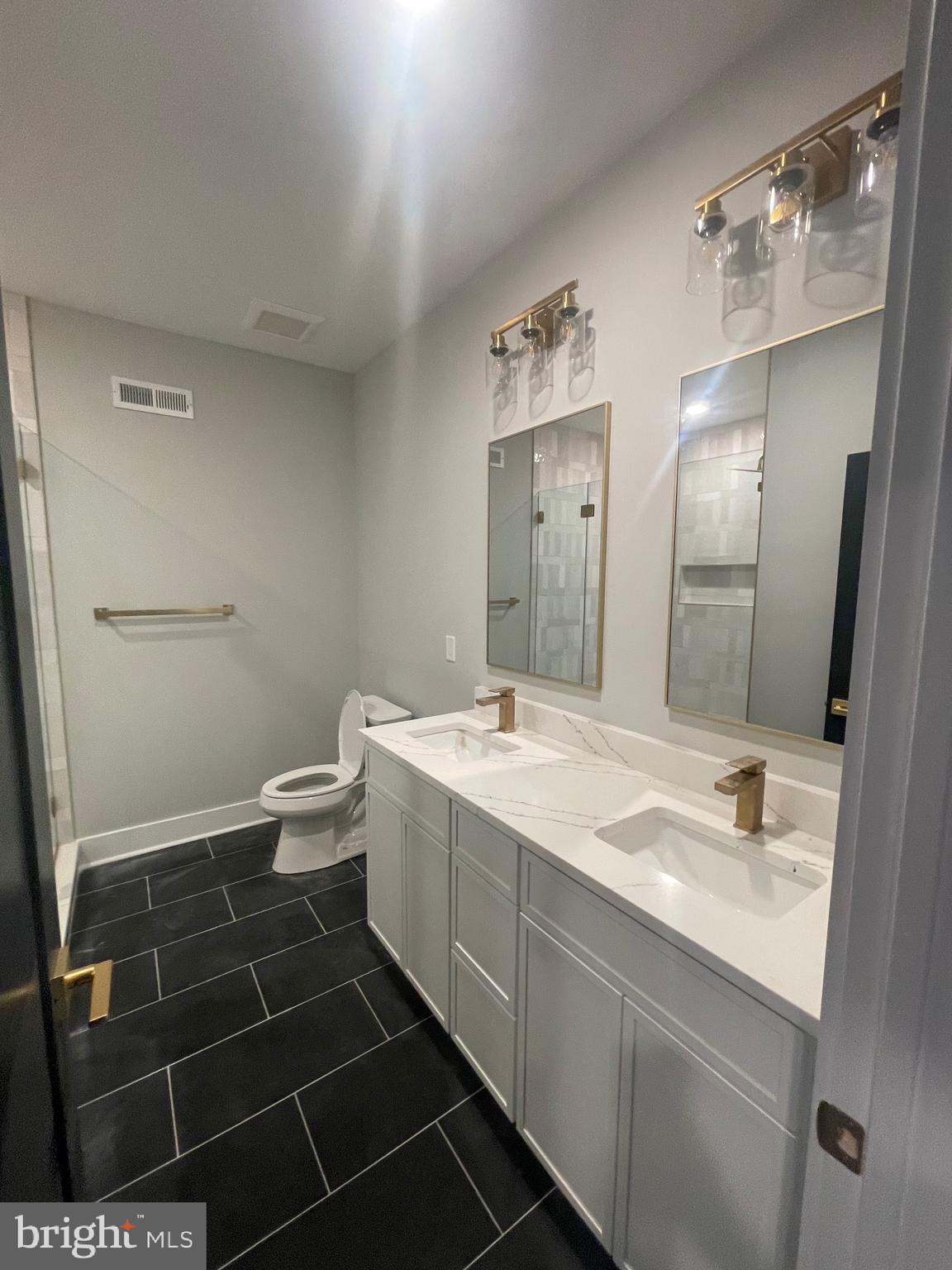 7521 Ridge Avenue Philadelphia, PA 19128 - Photo 12 of 13 a bathroom with a sink a toilet and shower