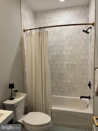 a bathroom with a toilet a sink and a bathtub