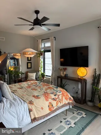 a bed sitting in a bedroom and flat screen tv