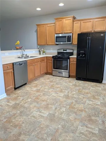 a kitchen with stainless steel appliances granite countertop a stove top oven a sink and dishwasher