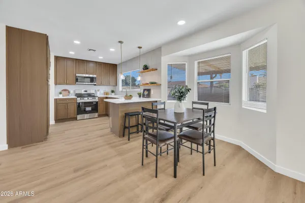 a view of a dining room with furniture and wooden floor