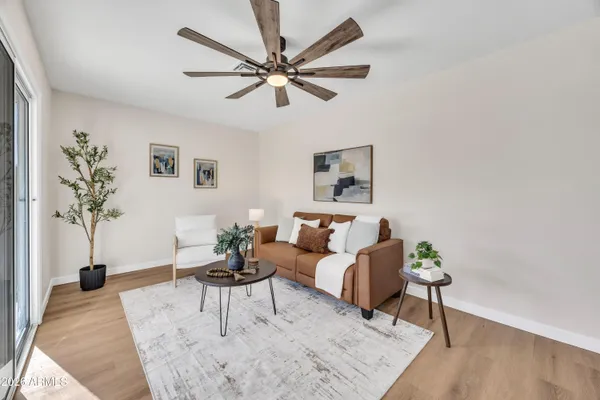 a living room with furniture and a potted plant
