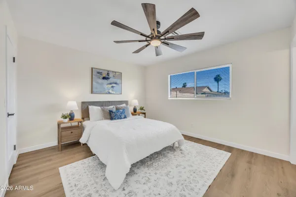 a bedroom with a large bed and a chandelier