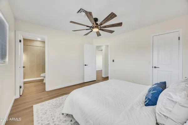 a bedroom with a bed and a chandelier