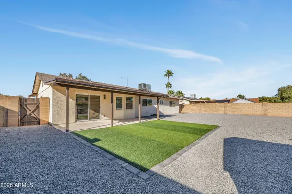 a view of a house with a yard and sitting area
