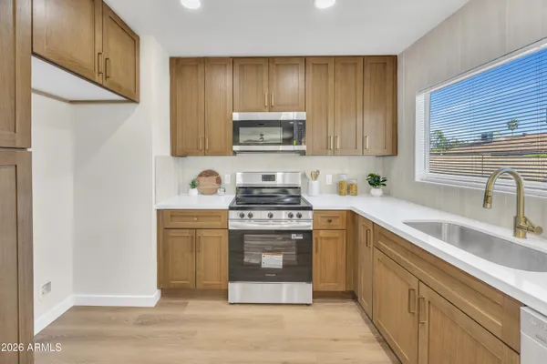 a kitchen with a sink cabinets and a window
