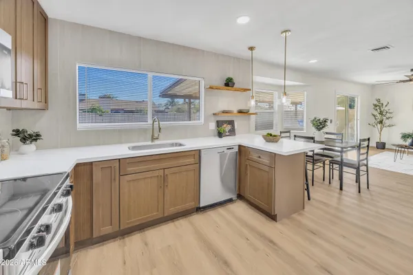 a kitchen with a sink stove and cabinets