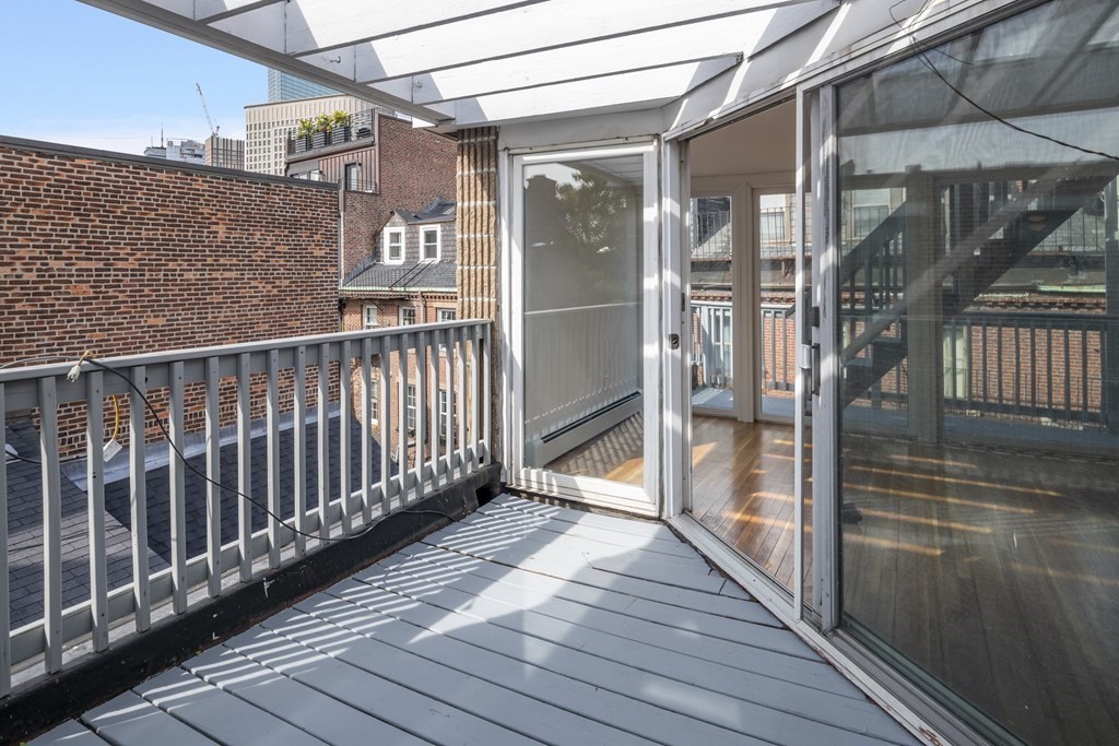 15 Fayette Street, Unit 7 Boston, MA 02116 - Photo 13 of 16 a view of a balcony with wooden floor