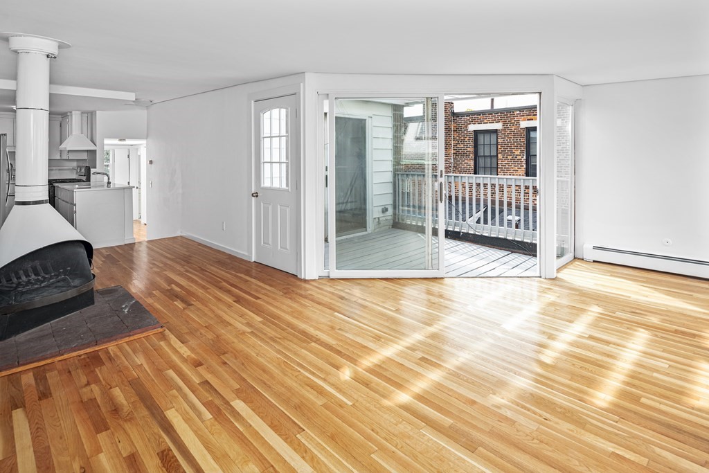 15 Fayette Street, Unit 7 Boston, MA 02116 - Photo 2 of 16 a bedroom with a bed and wooden floor