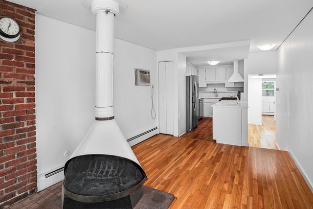 a view of kitchen with refrigerator and cabinets