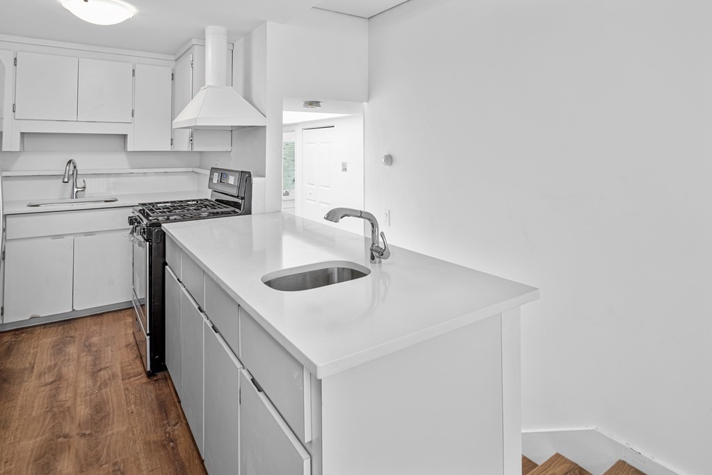 15 Fayette Street, Unit 7 Boston, MA 02116 - Photo 5 of 16 a kitchen with a sink a stove and cabinets