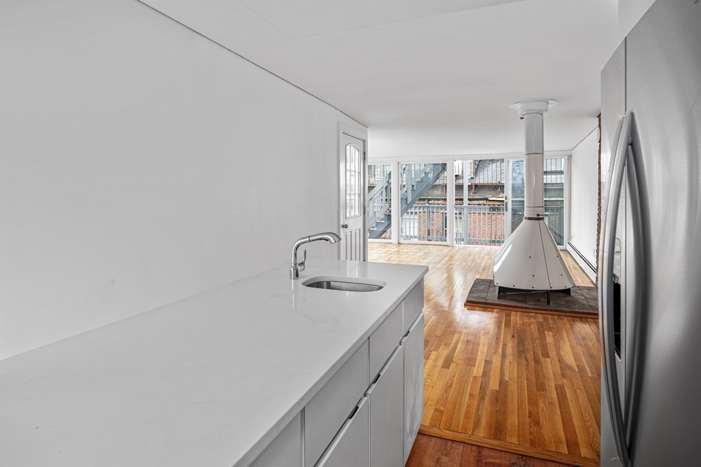 15 Fayette Street, Unit 7 Boston, MA 02116 - Photo 7 of 16 a spacious bathroom with a sink and mirror