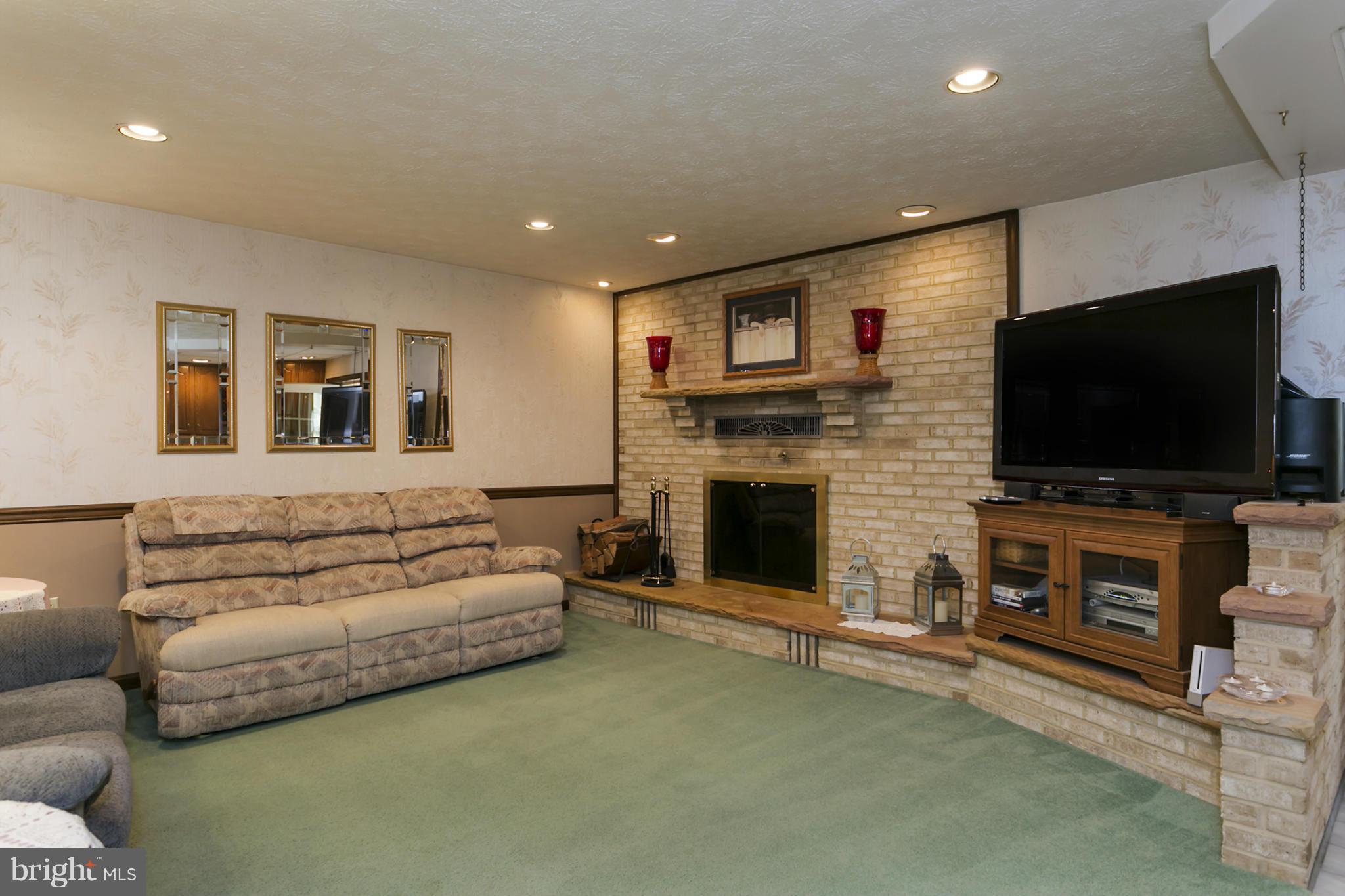 10009 German Road Ellicott City, MD 21042 - Photo 15 of 27 a living room with fireplace furniture and a flat screen tv