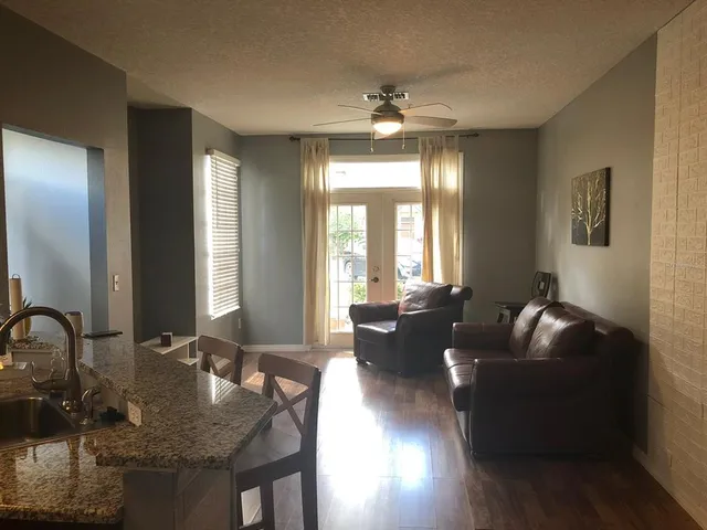 a living room with furniture and wooden floor