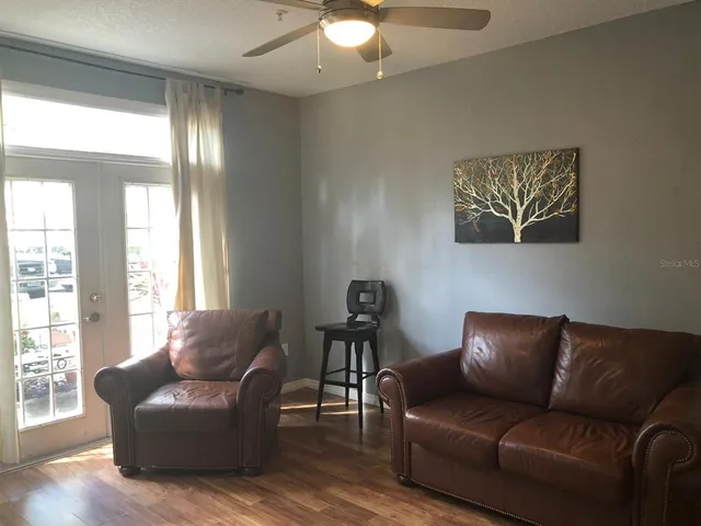 a living room with furniture and a large window