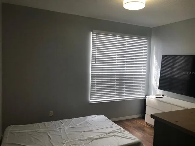 a bedroom with a bed and a window