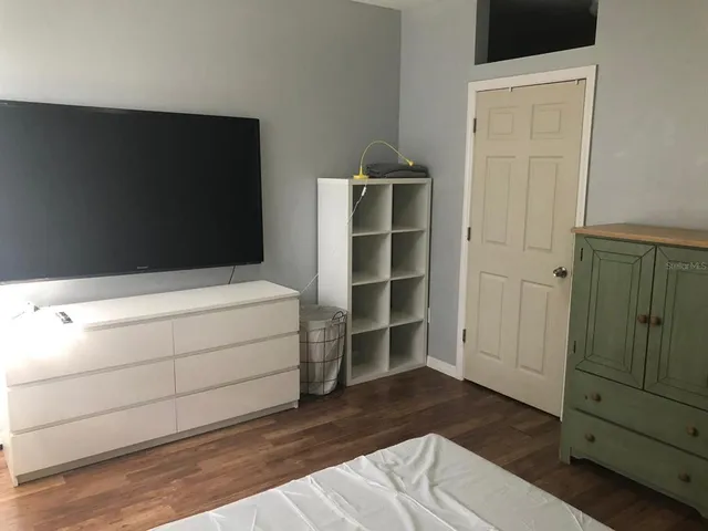 a room with a furniture and a flat screen tv