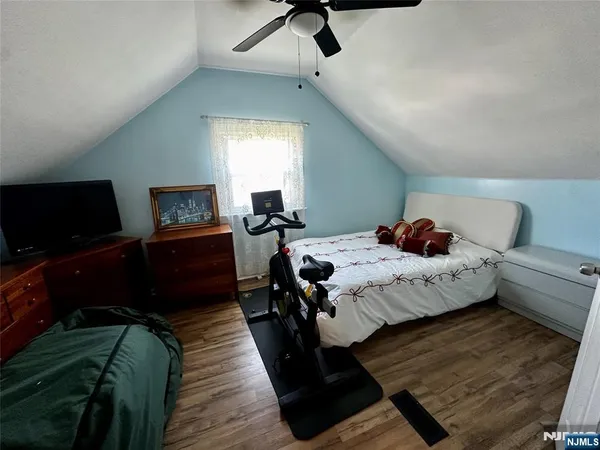 a bedroom with a bed and a television