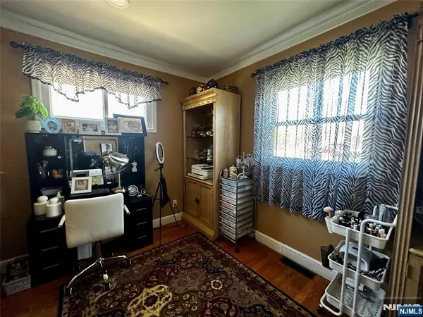 a room with lots of wooden furniture and windows