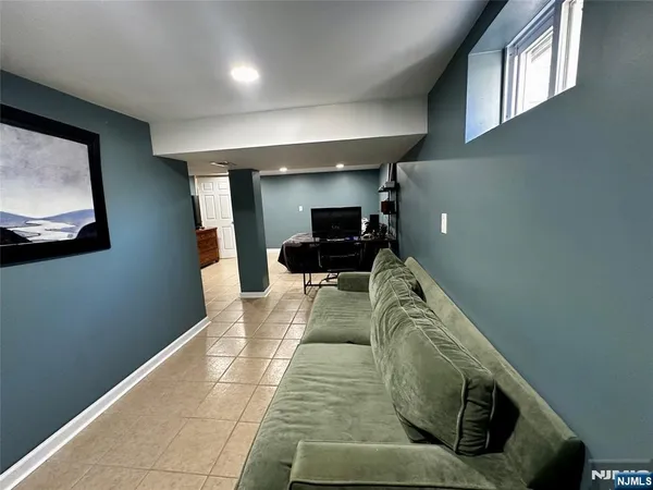 a view of living room with furniture and a painting