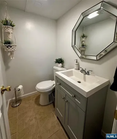 a bathroom with a sink toilet and mirror