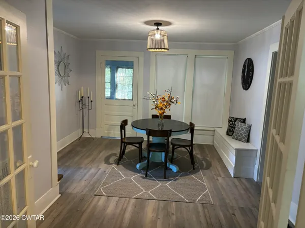 a dining room with furniture and window