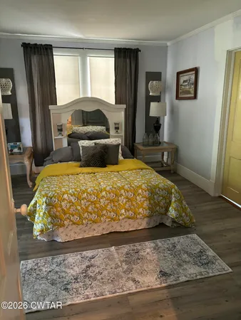 a bed sitting in a bedroom next to a window