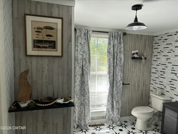 a bathroom with a toilet a sink and shower
