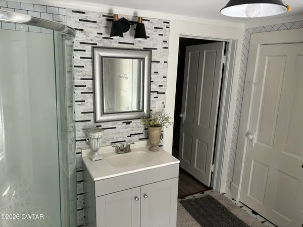 a bathroom with a sink and a mirror