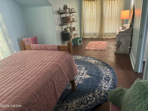 a bedroom with a large bed and a window