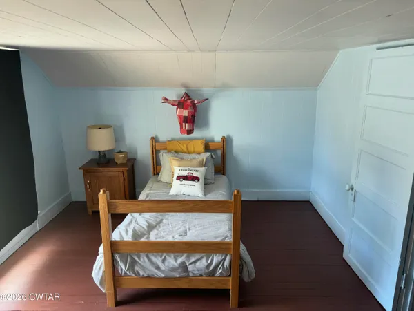 a bed sitting in a bedroom next to a cabinet