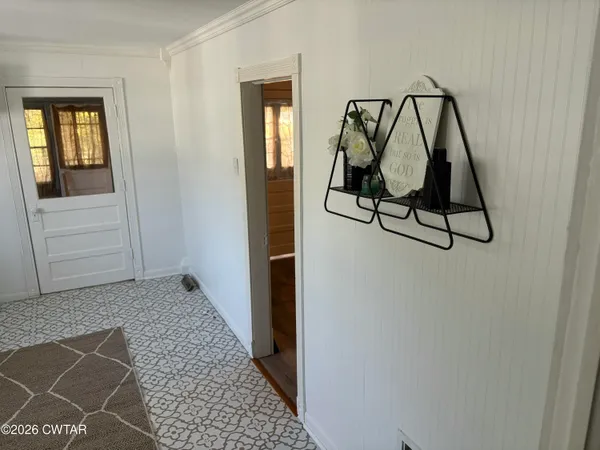 a view of an entryway with wooden floor