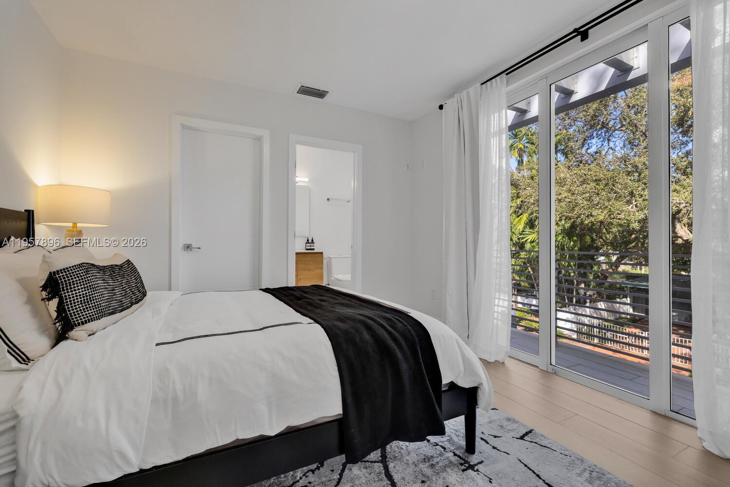 2851 Southwest 33rd Court, Unit 2851 Miami, FL 33133 - Photo 26 of 45 a bedroom with a bed and wooden floor