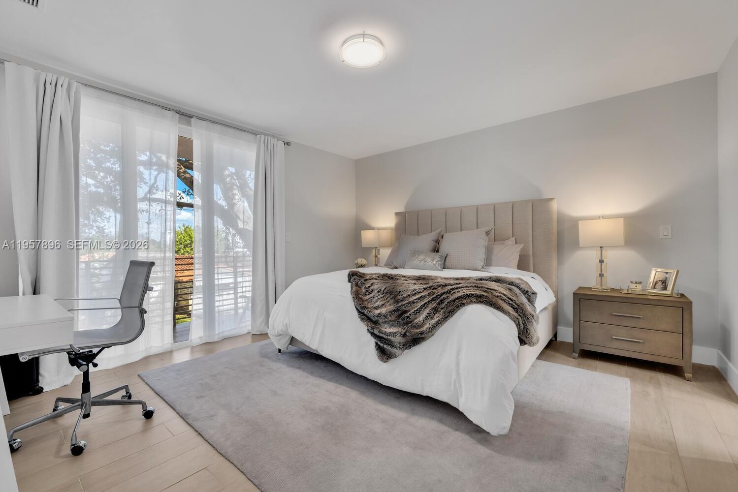 2851 Southwest 33rd Court, Unit 2851 Miami, FL 33133 - Photo 31 of 45 a bedroom with a bed and a table in it