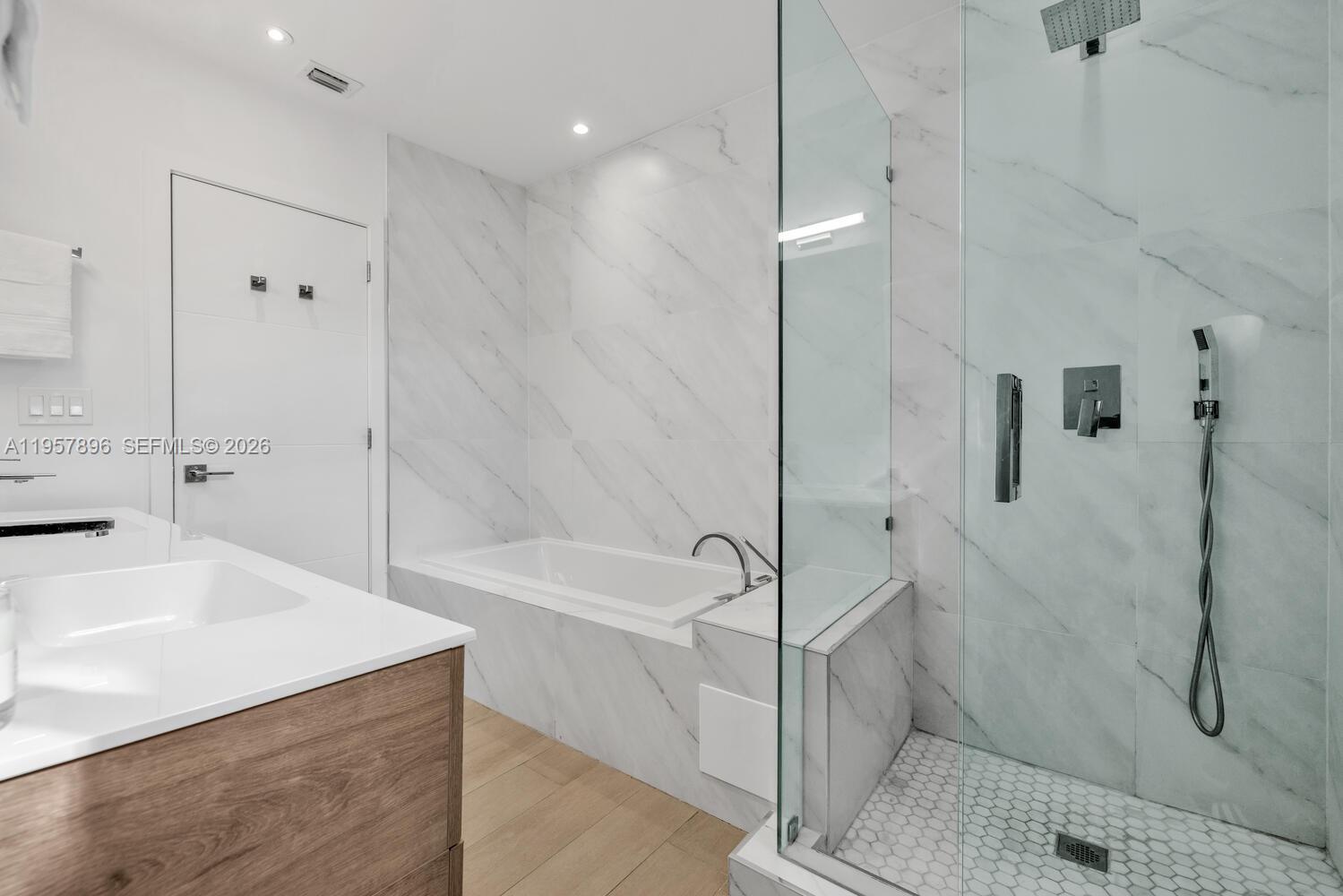 2851 Southwest 33rd Court, Unit 2851 Miami, FL 33133 - Photo 36 of 45 a spacious bathroom with a tub shower and sink
