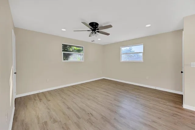 wooden floor in an empty room with a window