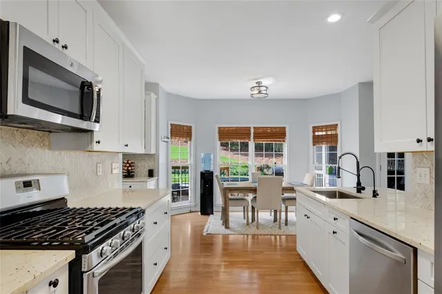 a kitchen with a sink cabinets and wooden floor