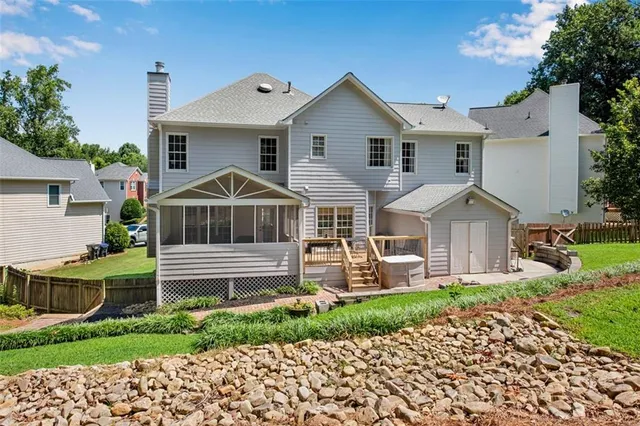 a view of a swimming pool with lawn chairs and a yard