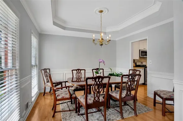 a view of a dining room with furniture and chandelier
