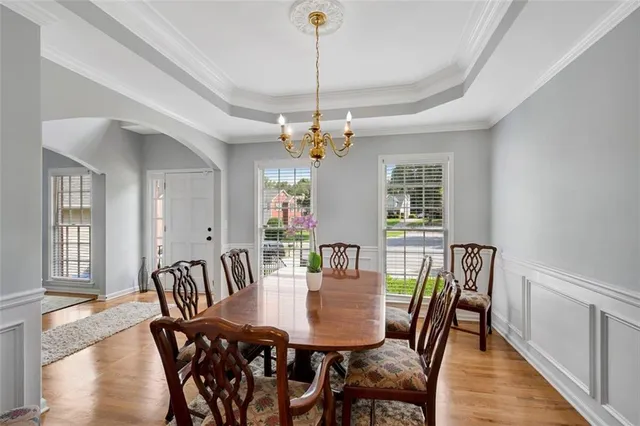 a view of a dining room with furniture and wooden floor