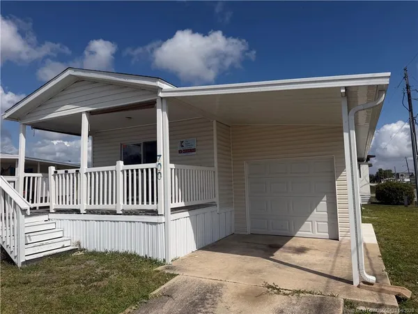 a side view of a house with a fence