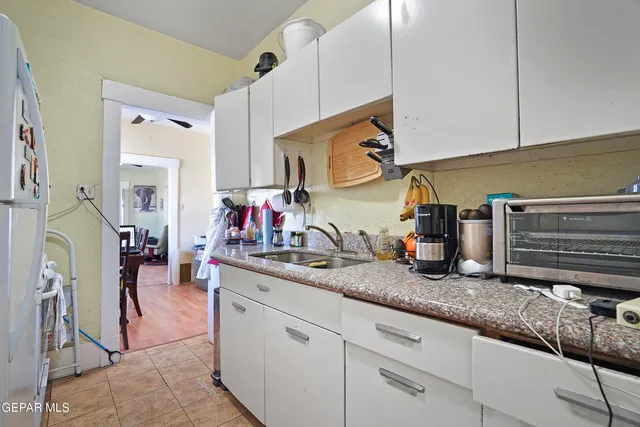a kitchen with sink and cabinets