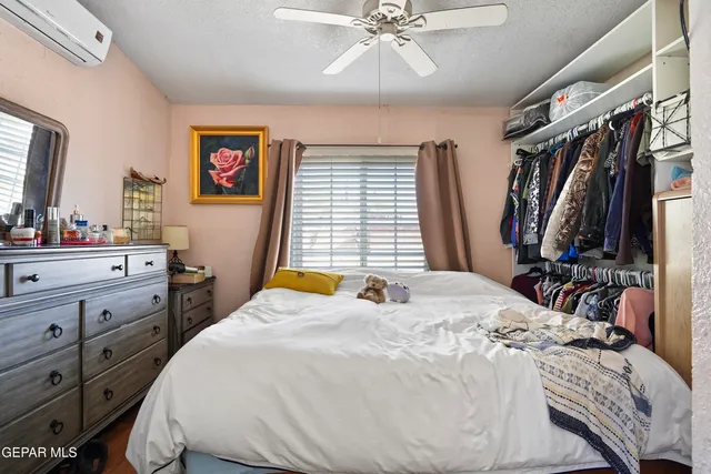 a bed room with a bed and a flat tv screen