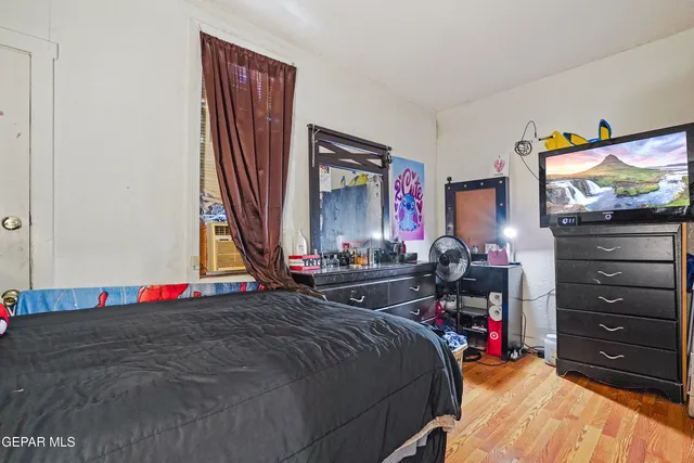 a bed room with a bed and a television