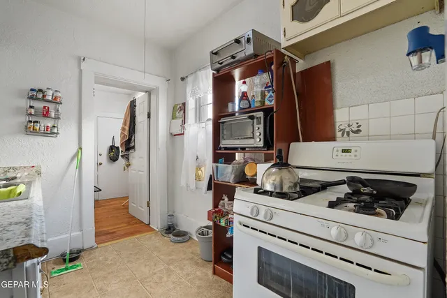 a kitchen with a refrigerator and a stove