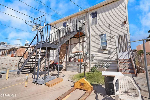 a view of a patio with a table and chairs